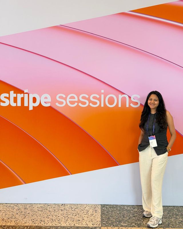 Shreya at Stripe Sessions 2026 in front of the event wall